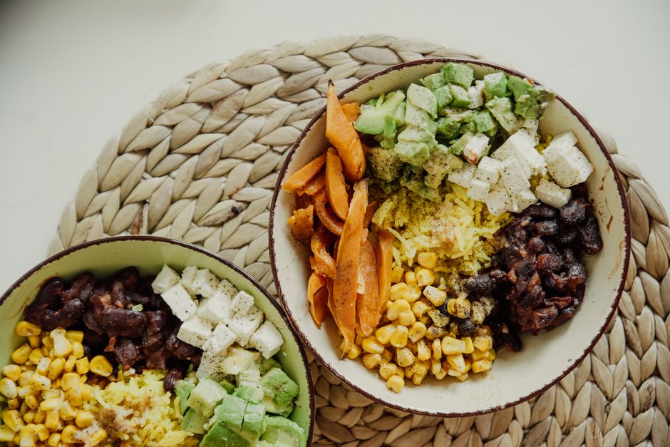 Build-your-own bowl ingredient station with organized bowls of fresh vegetables, grains, and proteins