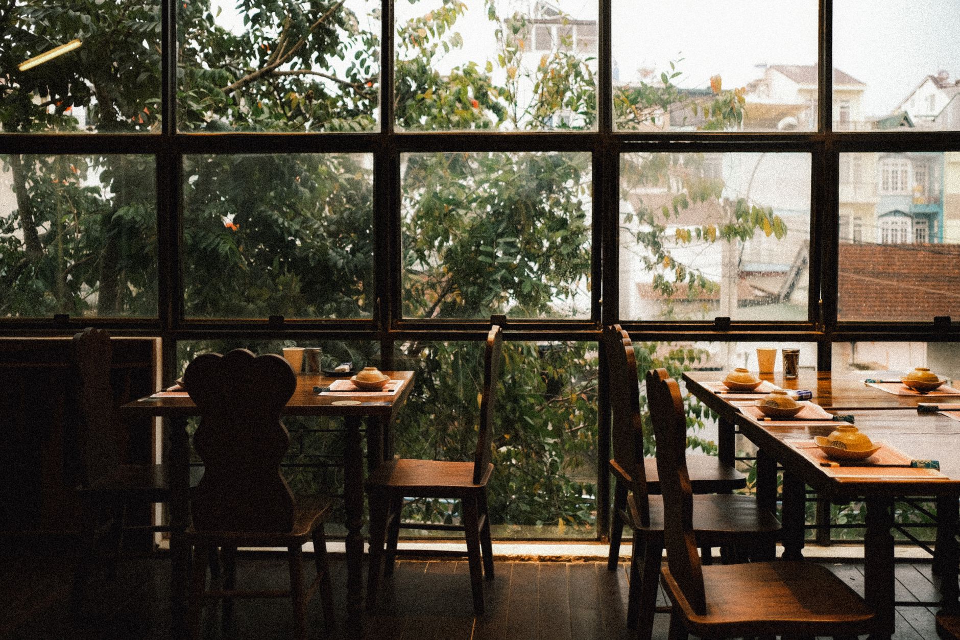 Restaurant dining room with large windows overlooking a city street